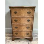 A reproduction walnut dwarf chest of serpentine outline having four graduated drawers on bracket