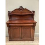 A 19th century mahogany chiffonier having a raised back with applied moulded foliage and