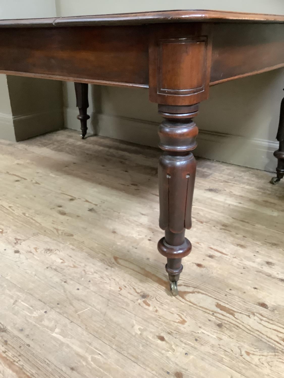 A Victorian mahogany dining table, rectangular with rounded corners, on inverted tulip and turned - Image 3 of 4