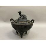 A Chinese bronze korro of bowl form with twin handles, the cover with dog of Fo finial and on