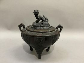 A Chinese bronze korro of bowl form with twin handles, the cover with dog of Fo finial and on