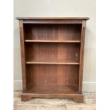 A set of oak open book shelves on shaped plinth base, 76cm wide by 27cm deep by 97cm high