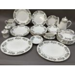 A Crown Staffordshire dinner service comprising lidded tureen, two oval meat dishes, four dinner