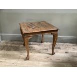 An Indian hardwood and brass inlaid games table of square section on stylised cabriole legs, 51cm