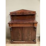 A Victorian mahogany chiffonier having a raised arched back with shelf and turned uprights, frieze