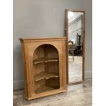 A pine hanging corner cupboard with open serpentine fronted shelves together with a pine framed