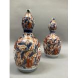 A pair of late 19th century Imari double gourd shaped vases painted in under glaze blue, iron red