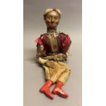 An English string puppet of a Moroccan juggler, painted features, wearing a silk turban and