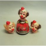 A Japanese tin plate wind-up bumper car and driver with three different rubber clowns' head, 14cm