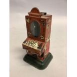 An early 20th century tinplate chocolate dispenser, possibly German, of vending machine form with