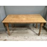 A pine kitchen table on turned legs, 153cm wide by 75cm deep