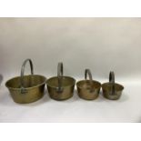 Four brass preserve pans with iron hoop handles, graduated sizes