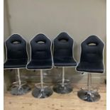 A set of four black leatherette and white trimmed breakfast bar chairs on chrome circular bases