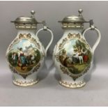 A pair of German porcelain and white metal lidded wine flagons printed with views of figures in a