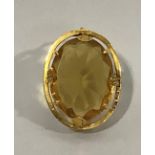 A Victorian 12ct gold brooch the oval bezel claw set to the centre with a later oval faceted