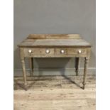 A pine table with short raised back, two drawers to the apron, ceramic handles, on turned legs, 99cm