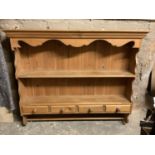 A pine wall rack with four drawers, 123cm wide, 105cm tall approximately