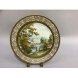 A Cauldon china plate painted to the centre with a view of Chatsworth House, signed W.E. Mosely of