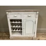 A cabinet with single door cupboard, drawer and wine rack