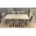 A cream wood effect extending dining table on square moulded legs with gadroon rim, rectangular with