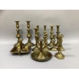 A quantity of brass candle sticks including four pairs, single sticks and two chamber sticks