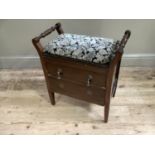 A piano stool with upholstered seat and two drawers below