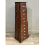 A tall hardwood chest of ten drawers of tapered form