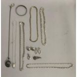 A collection of silver and white metal (test as silver) jewellery including faceted curb, figural