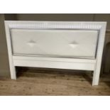 A white buttoned leatherette and laminated headboard, 215cm wide