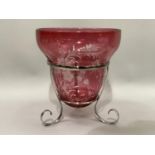A cranberry and clear cut glass vase of inverted bell shape held in a silver plated frame on three