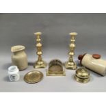 A pair of Victorian brass candlesticks, a later desk bell, a letter rack, Benares trinket tray, a