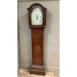 A 19th century oak longcase clock having an arched enamelled dial painted with strawberries to the