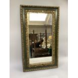 A rectangular wall mirror in green and gilt frame, 75x44cm, early 20th century