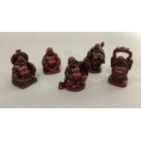 Five resin Chinese style figures of Buddha in different poses