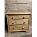 A Victorian revival pine chest of two short and two long drawers, turned handles and feet