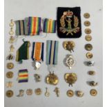 A collection of brass military buttons, cap badges, insignia etc