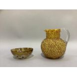 A Victorian yellow and russet splashed glass jug, of writhen moulding, reeded clear handle, 15cm