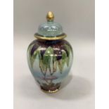 A modern 'Carltonware' vase and domed cover with gilt knob, of tree and swallow design, ltd