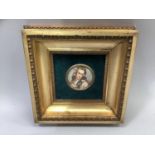 A porcelain plaque painted with a head and shoulders portrait of a girl with golden locks, a dove