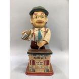 A mid 20th century tin plate batter operated bartender figure