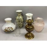 A brass oil lamp with chimney, a pale pink mottled glass two handled urn, an Aynsley china flower