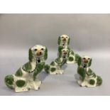 Two pairs of reproduction Staffordshire spaniels sponged in green and of graduated size by