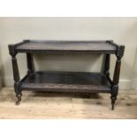 An oak carved dumb waiter (reduced in height), 117cm wide by 74cm high