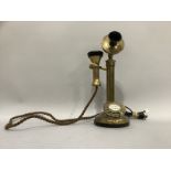 A reproduction brass candlestick telephone with modern jack