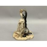 A 20th century Italian ceramic group of a couple in elegant attire dancing to a gramaphone. Signed