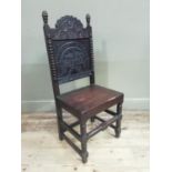 A 19th century oak single chair with arched and carved back panel, bobbin turned pilasters, stylised