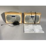 Two Pure DAB radios with instruction manuals and plugs
