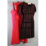 An unusual plum and black evening dress with integral coat effect, short sleeves, floral design; a