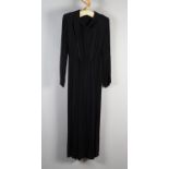 An elegant black crepe full length evening dress with long sleeves with cuffs, slight drape to the