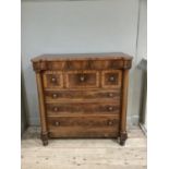 A 19th century figured mahogany chest of drawers having a concealed frieze drawer above three deep